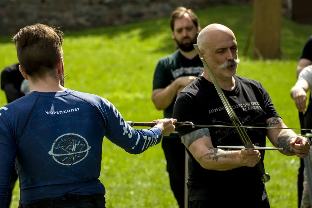 Instructor demonstrating a sword technique at an outdoor training